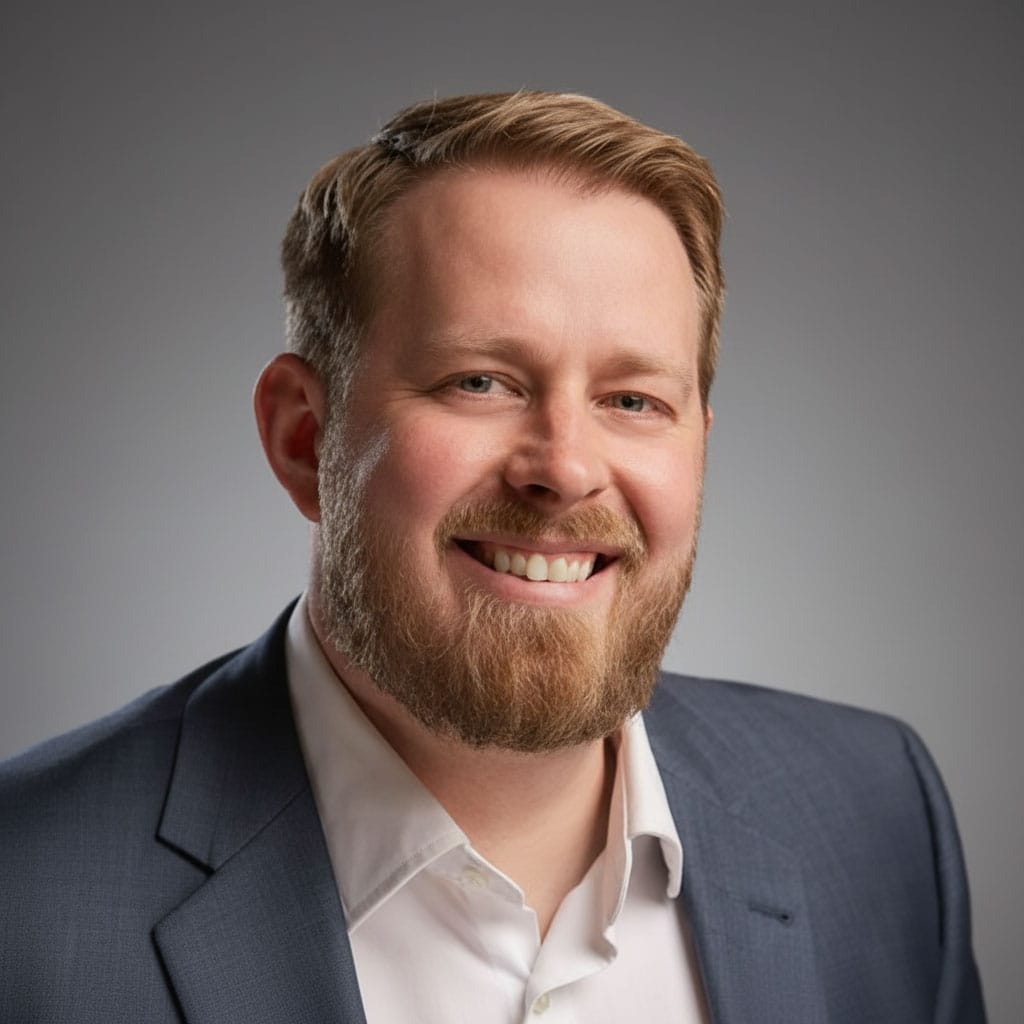 Professional business executive portrait, confident male leader in suit, corporate headshot, smiling professional photograph.
