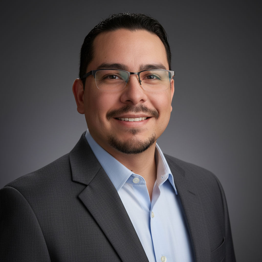 Confident business professional in suit and glasses, smiling on gray background.