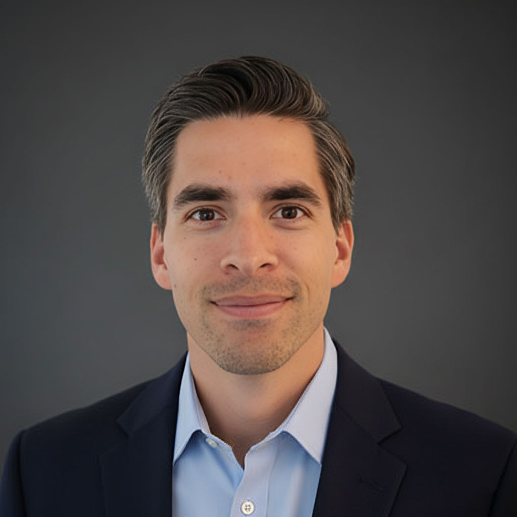 Professional businessman in a suit, corporate headshot, confident executive image.