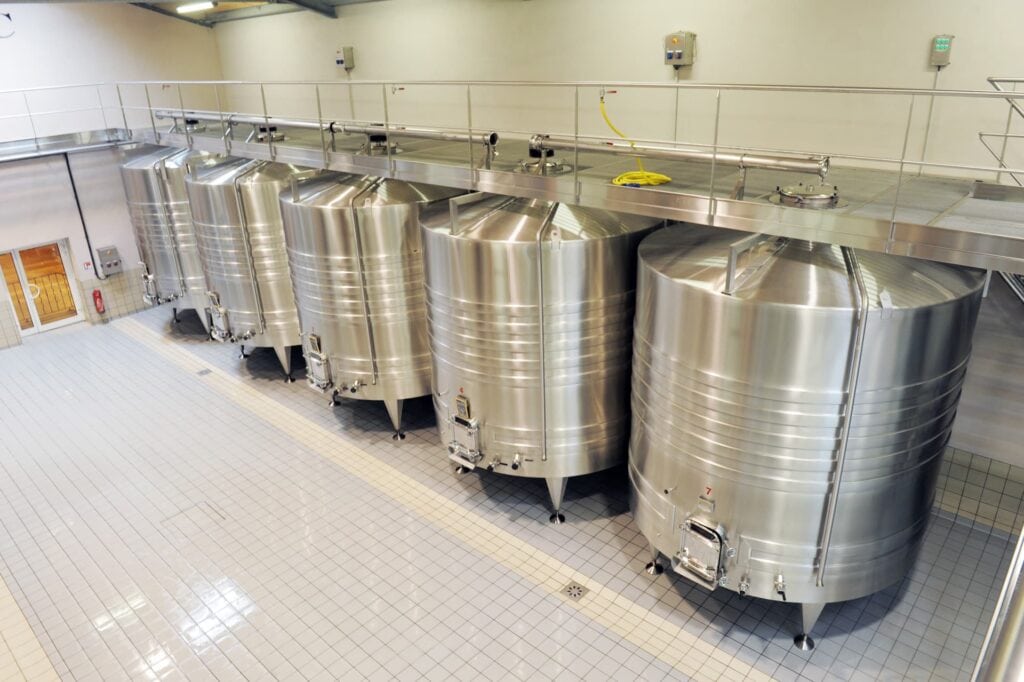 industrial storage tanks on a production line floor in a brewery