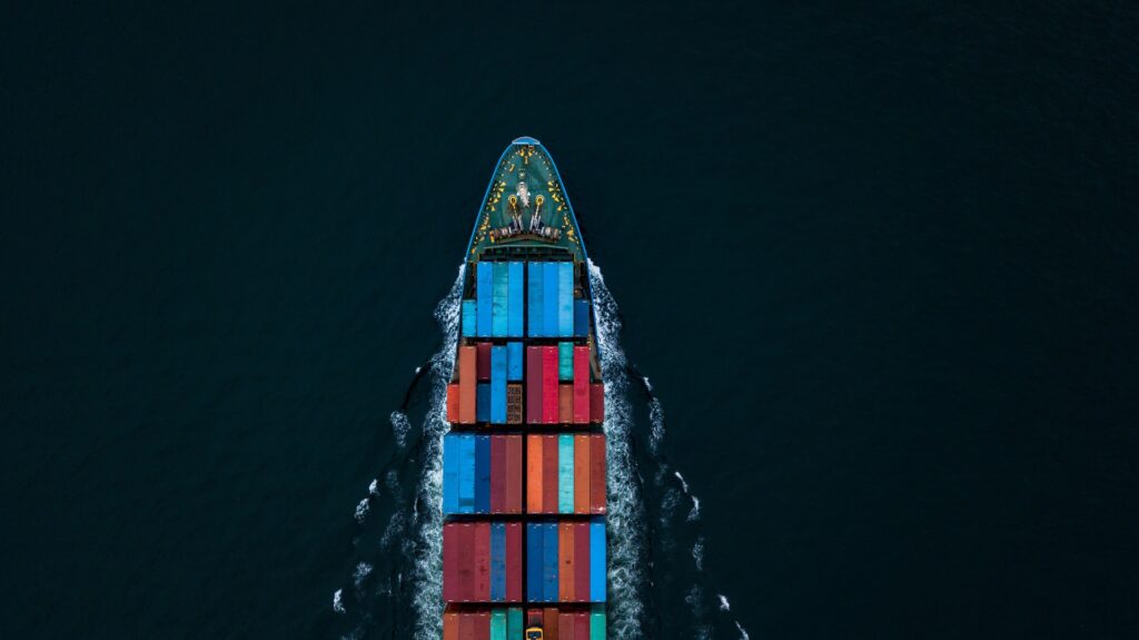 Container ship sailing on the ocean, representing global logistics and supply chain transportation.