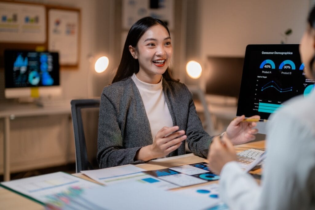 1. Businesswoman discussing data analytics at office meeting.