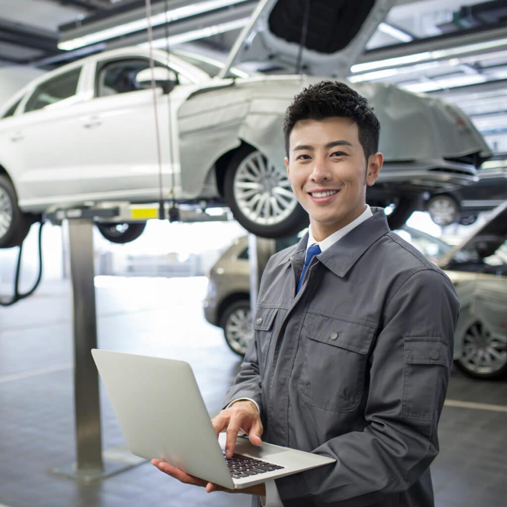 - Auto repair technician inspecting vehicles in a service center.