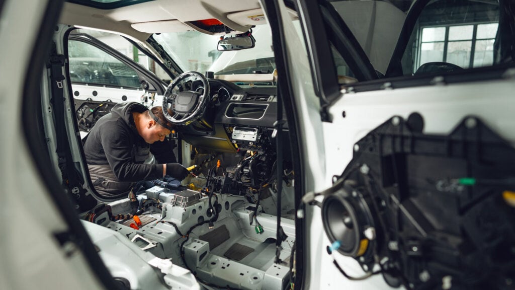 High-tech vehicle assembly and repair in progress at Concentrus automotive manufacturing plant.