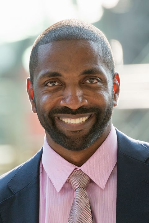 Bright smiling professional man in business suit, confident and approachable.