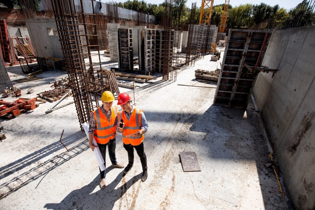 1. Hard hat construction workers on building site for infrastructure project.