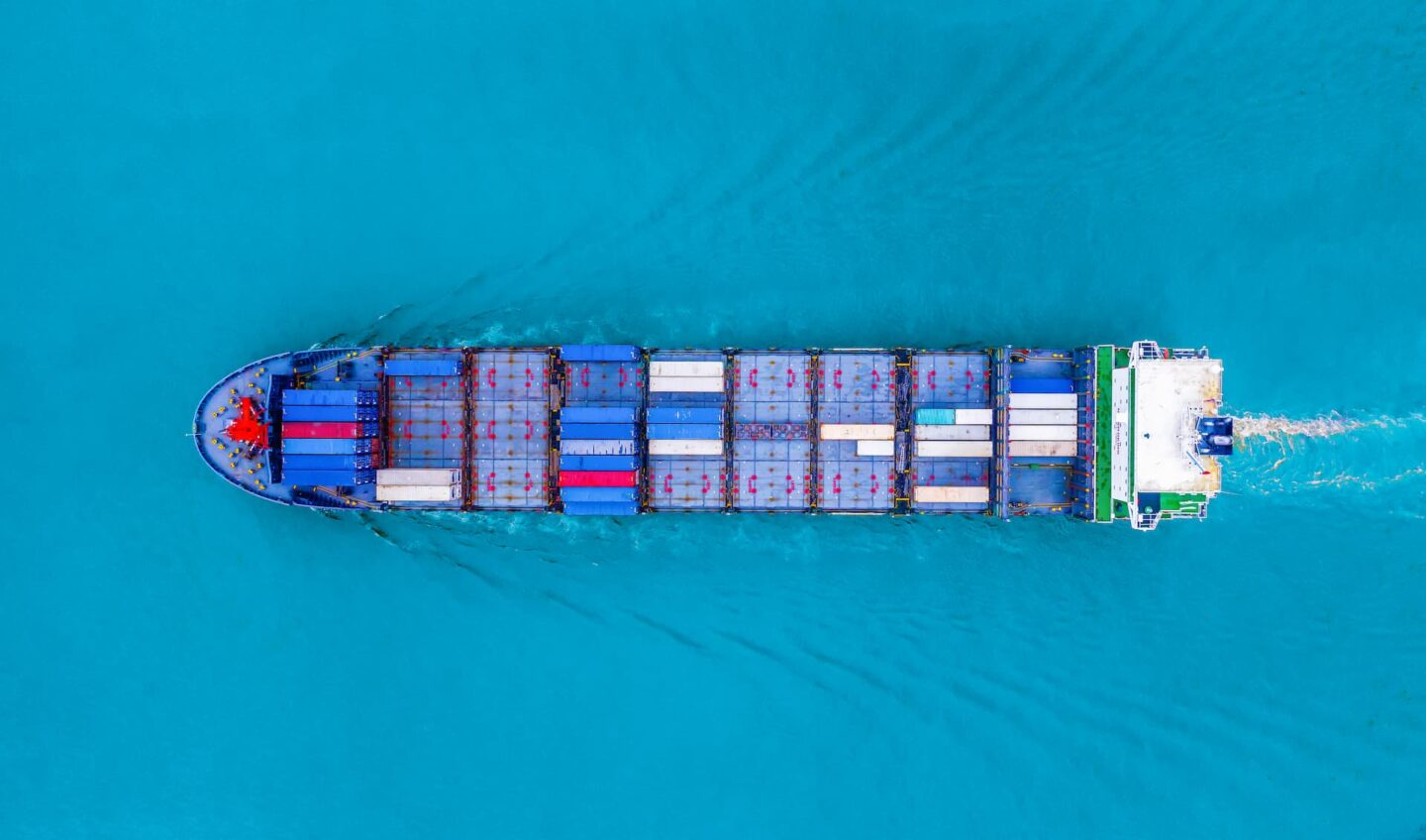 Cargo ship transporting containers across the ocean, representing global logistics and shipping services.