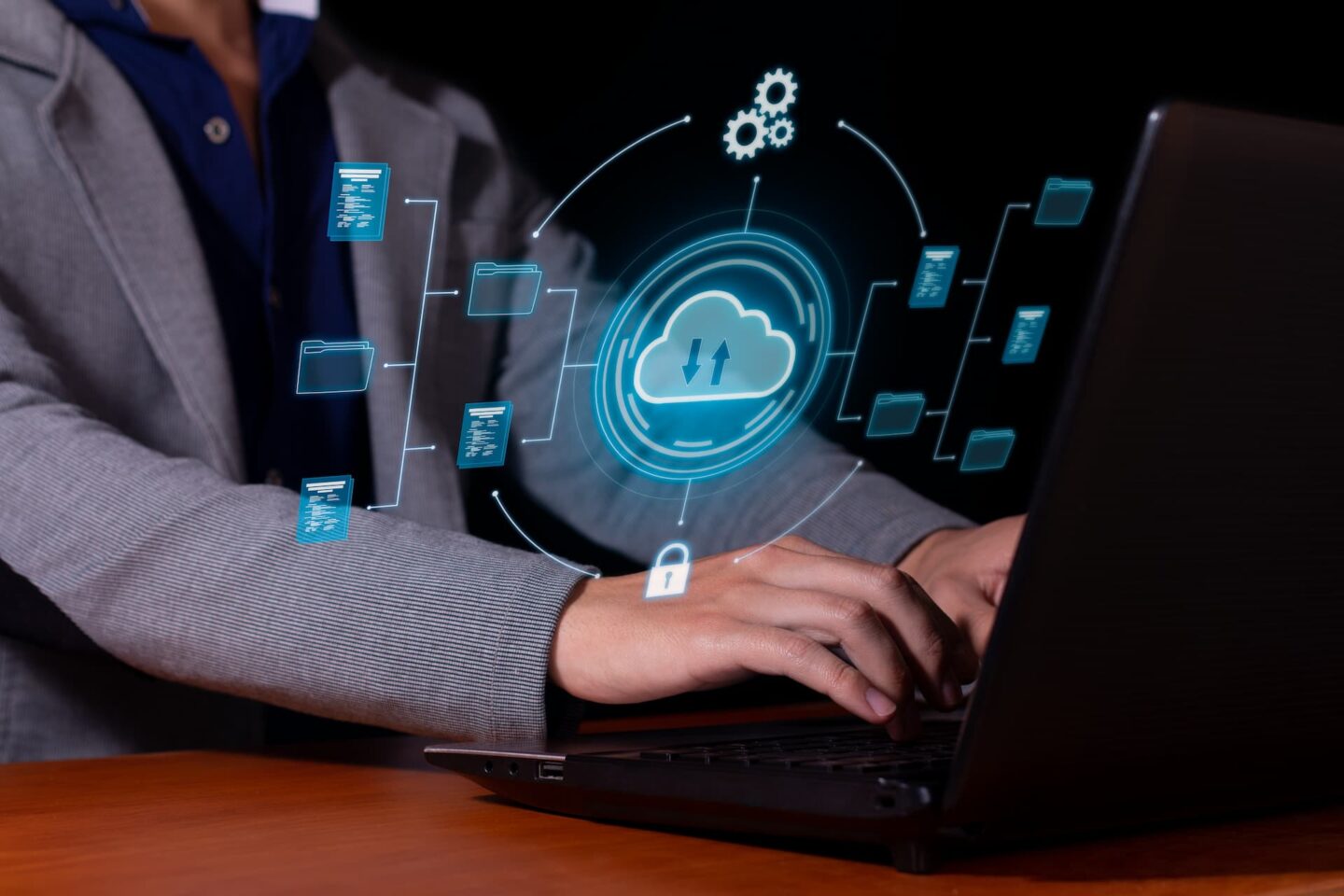 Cloud data management and cybersecurity concepts with a person using a laptop.