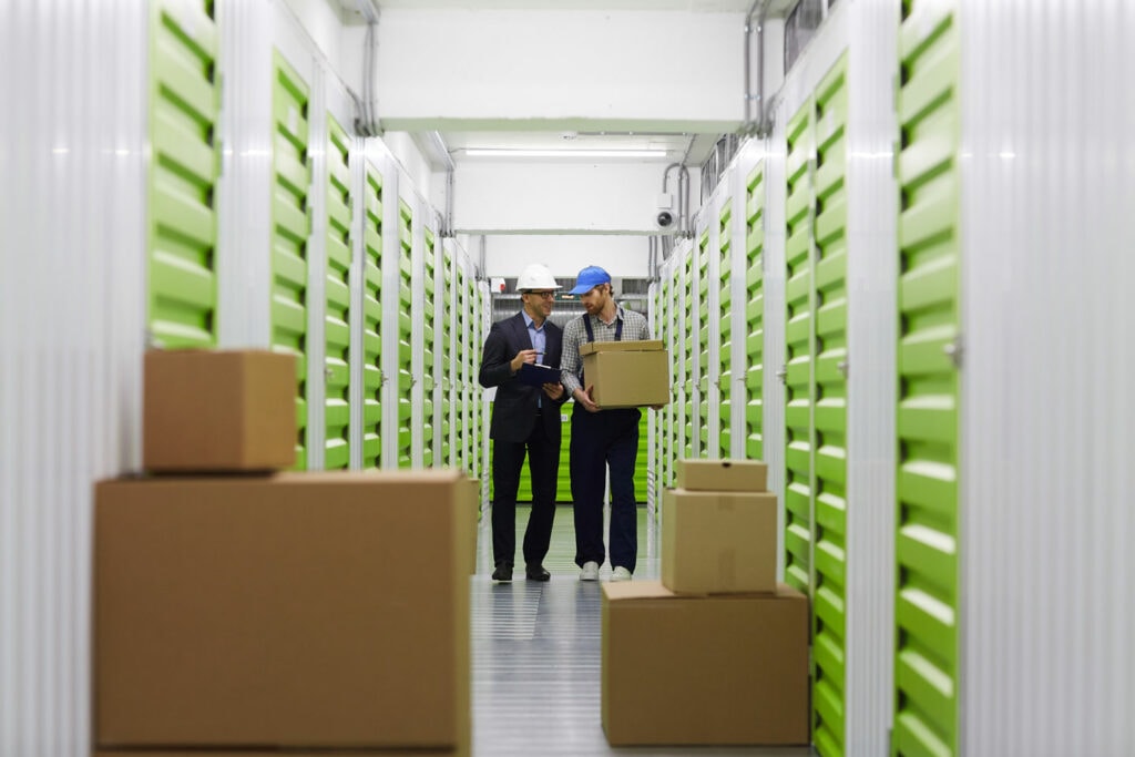 Efficient warehouse storage with green shelving for optimized inventory management.
