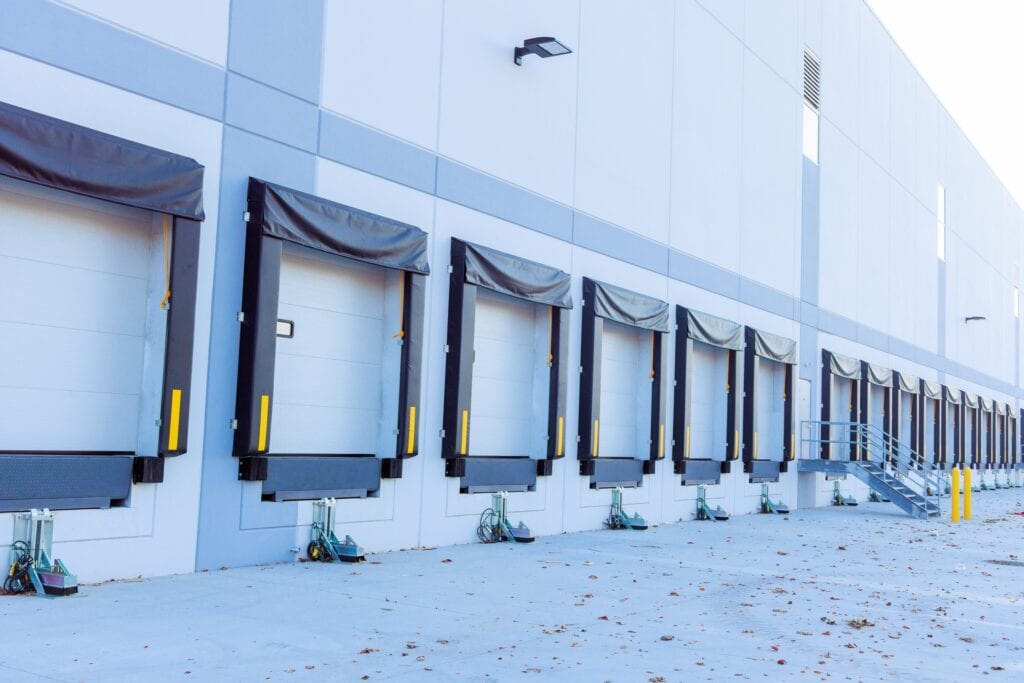 Flexible loading dock doors at a distribution center for efficient logistics and warehouse management.