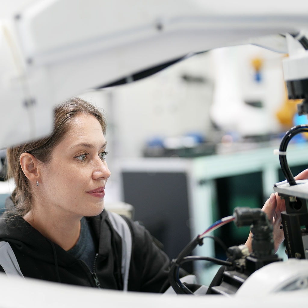 High-tech laboratory researcher working with electronic equipment, innovative scientific environment.
