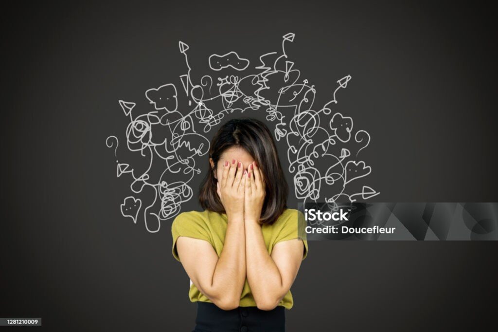 Overwhelmed woman with abstract doodles representing stress or anxiety, emphasizing mental health and emotional support.