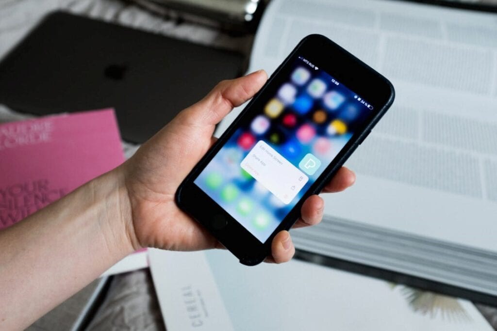 Smartphone receiving a Concentrus message on blurred background.