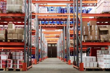 High-capacity warehouse shelving with pallets of industrial supplies and packaging materials.