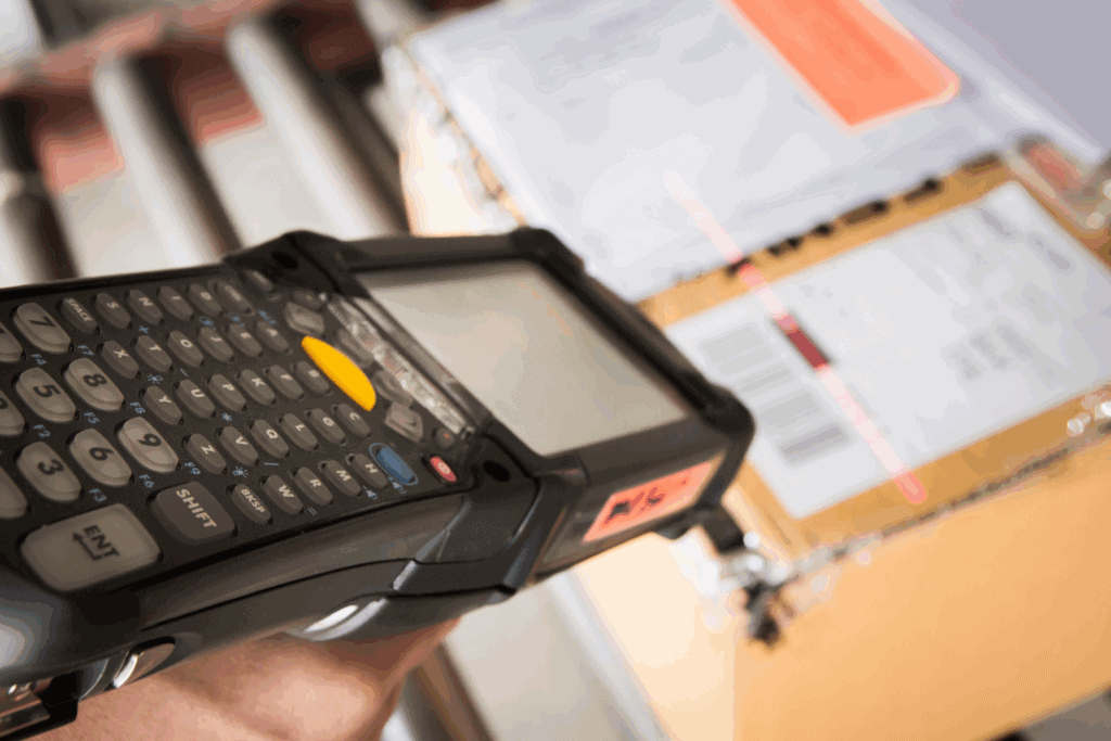 Barcode scanner, shipping labels on boxes, inventory management, logistics equipment, warehouse technology.