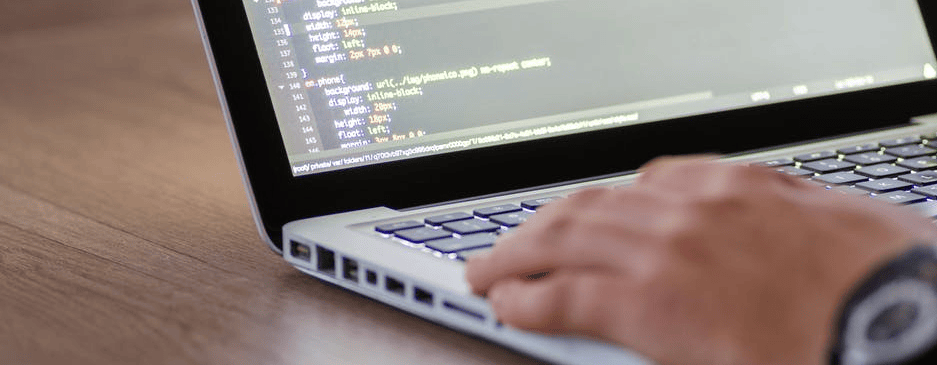 Code programming on a laptop for software development at Concentrus.