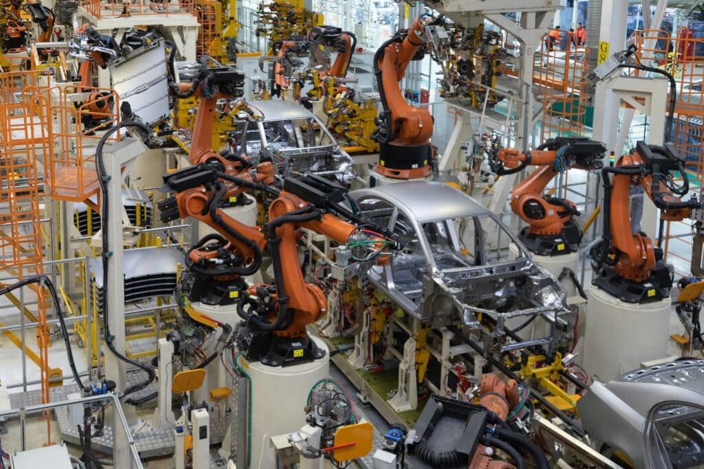 Robotic arms assembling car bodies on an automotive production line.