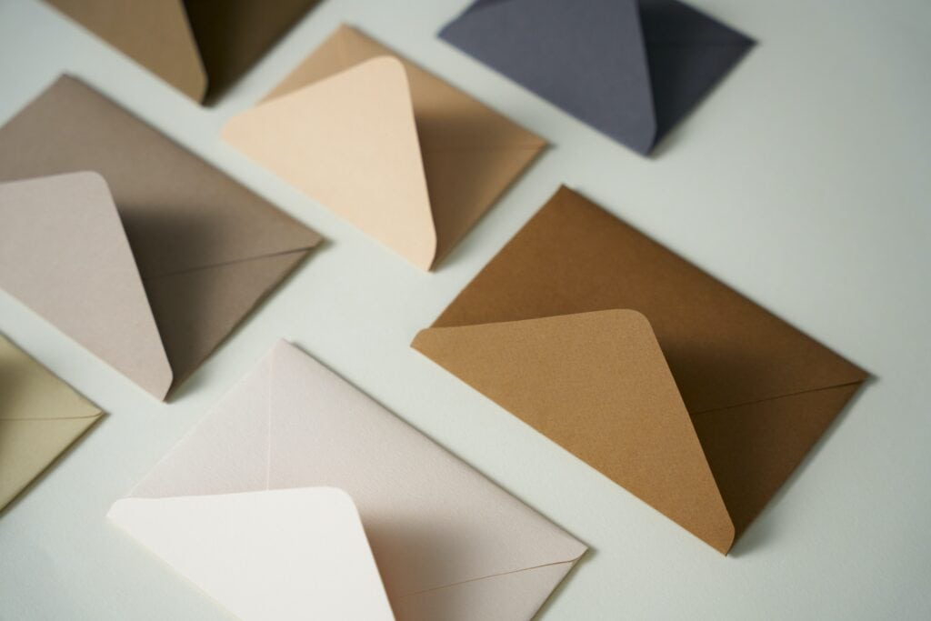 1. Colorful paper envelopes in various shades on white background.