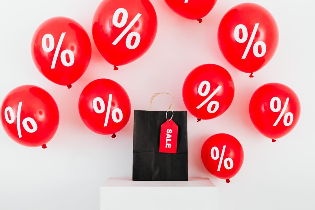 Red balloons with discount percentage symbols for sales promotion.