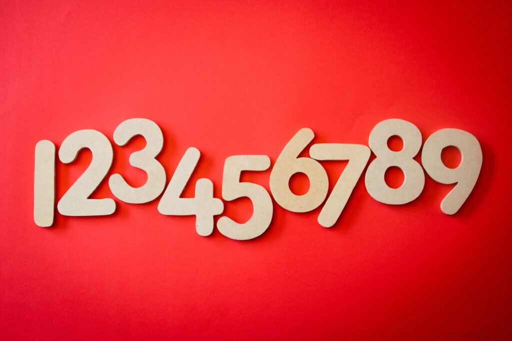 123456789 with numbers made of wood on a red background.