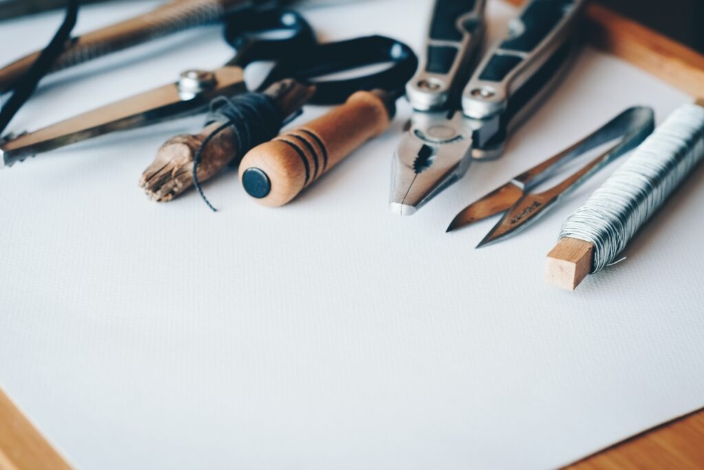 Assorted technical drawing tools on a white workspace.