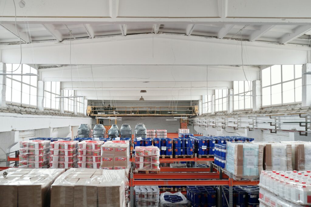 Industrial warehouse with storage shelves filled with construction materials and supplies.