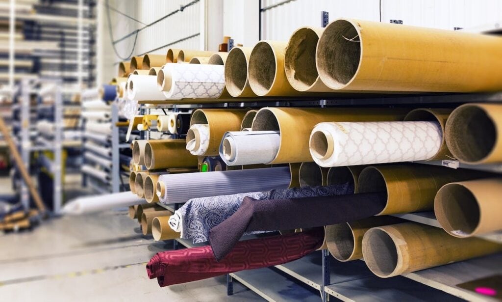 Colorful fabric rolls stored in a warehouse for interior design and home decor projects.