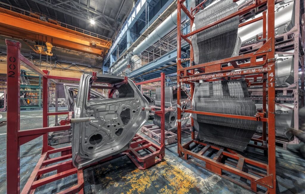 Metal automotive parts manufacturing in a high-tech factory setting.