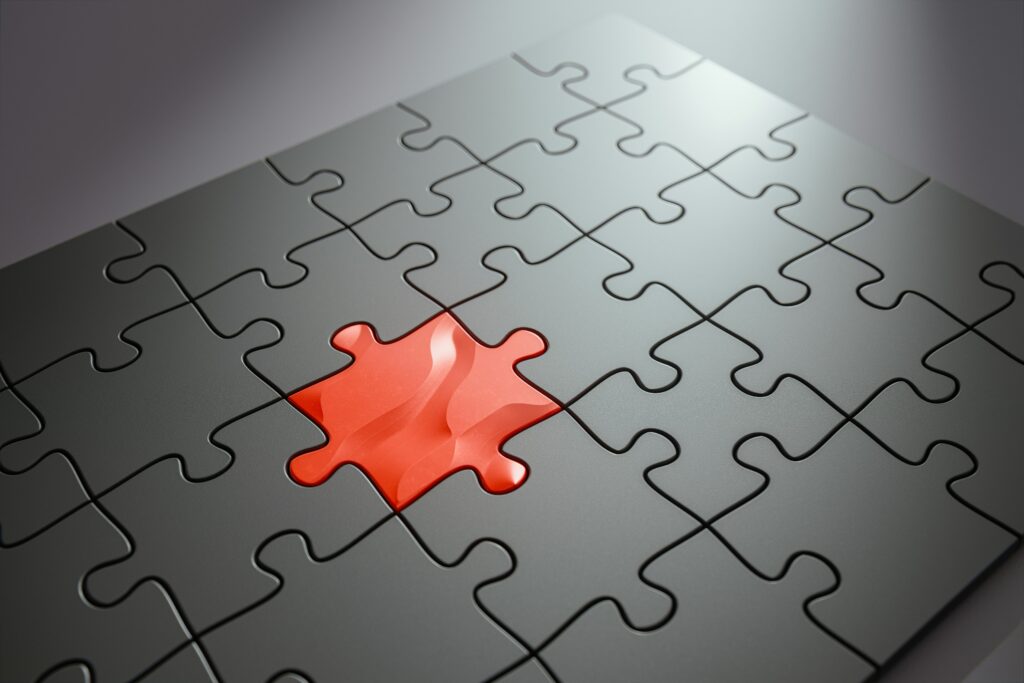 Black puzzle with missing red piece