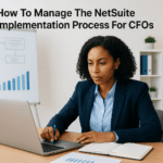 Professional woman working on a laptop with Netsuite implementation process chart in the background.