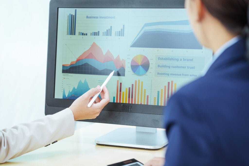 Data analytics and business growth charts on computer screen for strategic investment analysis.