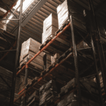 Warehouse storage racks with pallets and boxes for shipping and logistics.