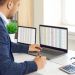 Business professional analyzing financial data on dual monitors for growth.