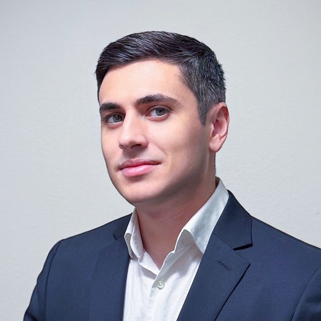 Gevorg Petrosyan, a professional associated with Concentrus, dressed in a formal suit, posing confid.