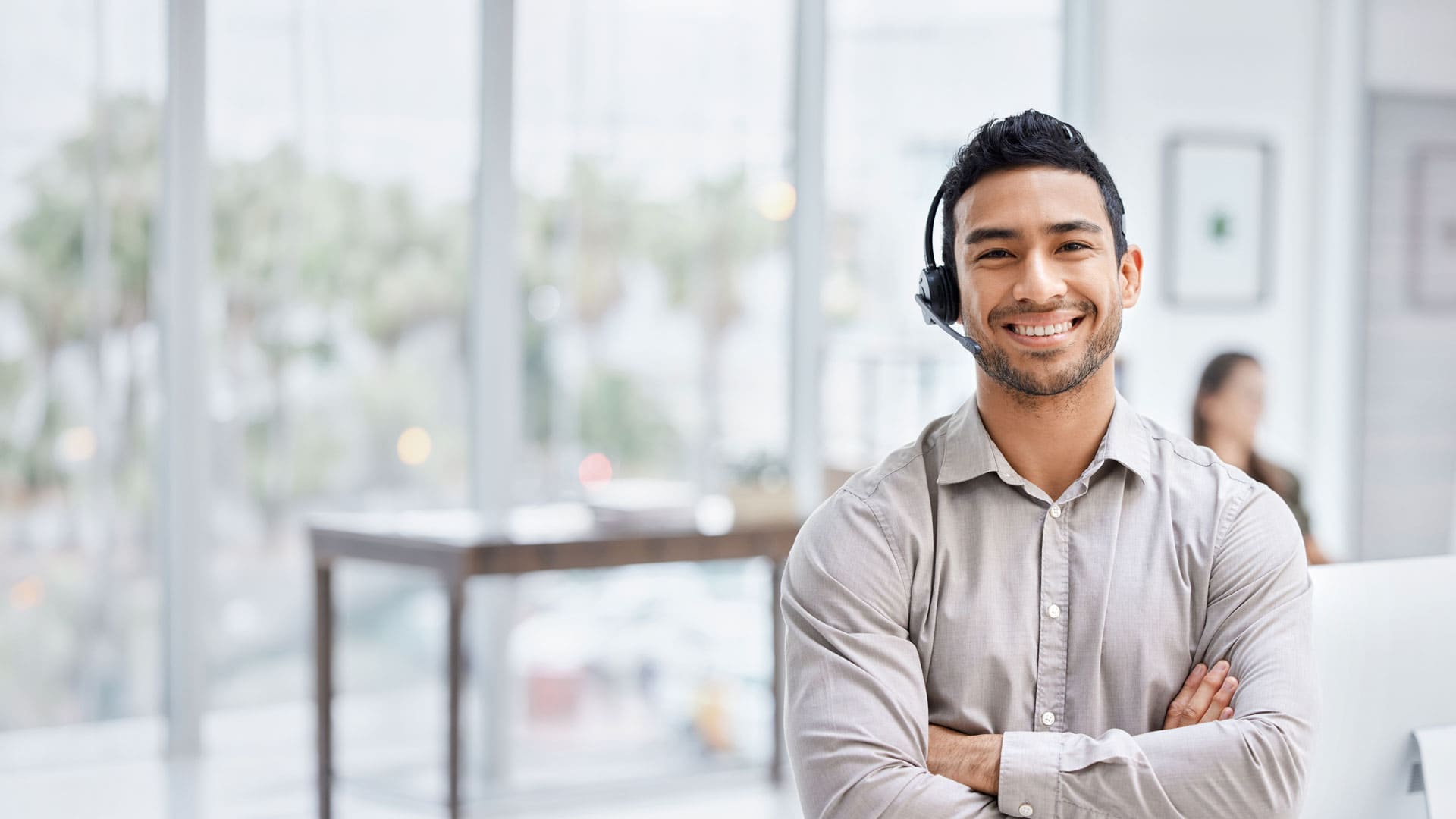 Smiling man in headset at office