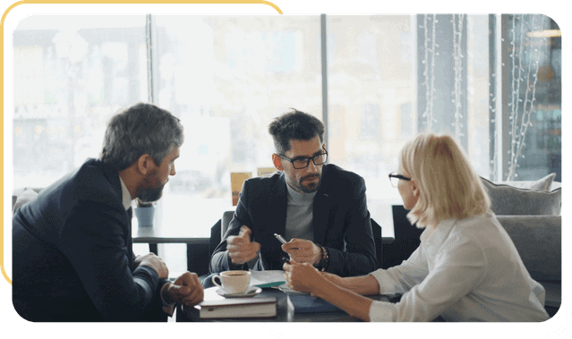 Business professionals discussing strategies at a conference table.