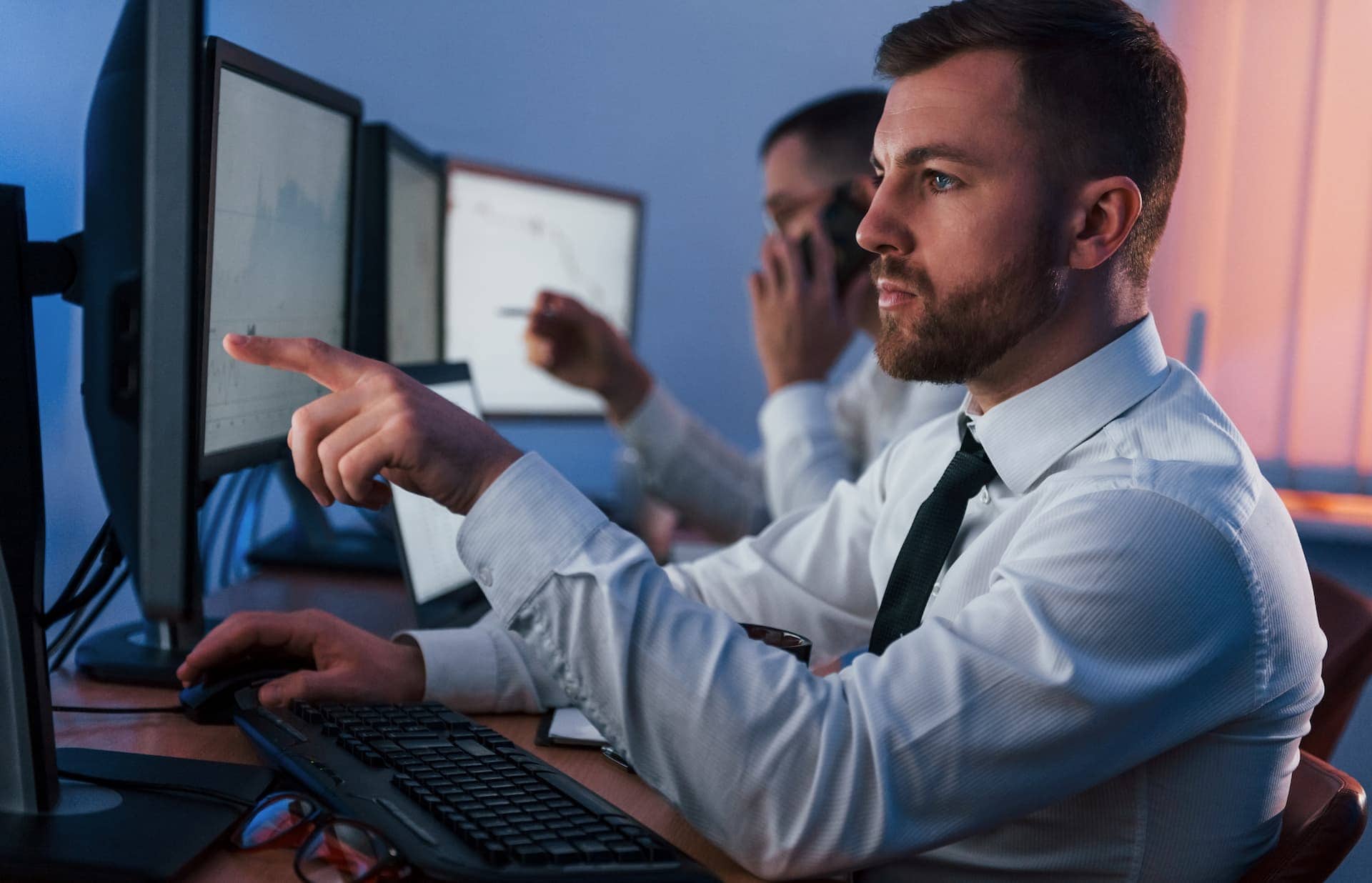 Two traders analyzing stock market data.