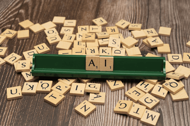 Wooden letter tiles scattered around a green rack with the letter "A".