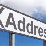 Street address sign pointing to address form customization in NetSuite.